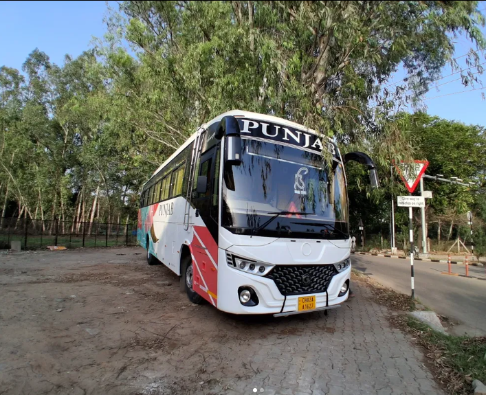 Punjab Travels luxury coach at dusk
